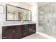 Elegant bathroom with double sinks, a large mirror, dark wood cabinets, and a spacious tiled glass shower at 1930 W Yellowstone Way, Chandler, AZ 85248