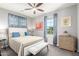 Cozy bedroom with soft blue accents, a comfortable bed, a ceiling fan, and plenty of natural light at 1930 W Yellowstone Way, Chandler, AZ 85248