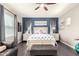 Bright bedroom featuring a ceiling fan, stylish decor, a comfortable king bed, and a cozy leather chair at 1930 W Yellowstone Way, Chandler, AZ 85248