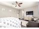 Bright bedroom featuring a ceiling fan, stylish decor, a comfortable king bed, a tv, and a cozy chair at 1930 W Yellowstone Way, Chandler, AZ 85248