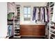 Organized walk-in closet with custom shelving, clothing racks, and a built-in wooden drawer unit at 1930 W Yellowstone Way, Chandler, AZ 85248