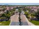 A neighborhood entrance showcases lush landscaping and palm trees along the main thoroughfare at 1930 W Yellowstone Way, Chandler, AZ 85248