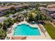 Community pool featuring lounge chairs, umbrellas, desert landscaping and nearby residential homes at 1930 W Yellowstone Way, Chandler, AZ 85248