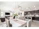Dining area with an elegant chandelier and views of the living room and modern kitchen at 1930 W Yellowstone Way, Chandler, AZ 85248