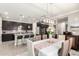 Dining area featuring modern chandelier, seating for six, and an open view of the kitchen at 1930 W Yellowstone Way, Chandler, AZ 85248