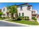 Charming stucco home with a well-manicured lawn and lush landscaping at 1930 W Yellowstone Way, Chandler, AZ 85248