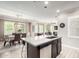 Kitchen island with stone countertops, stainless steel appliances, pendant lighting, and an open view of the dining area at 1930 W Yellowstone Way, Chandler, AZ 85248