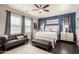 Main bedroom featuring a blue accent wall, a king-size bed, and a comfortable seating area at 1930 W Yellowstone Way, Chandler, AZ 85248