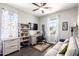 Well-lit home office featuring a ceiling fan, desk, bookcase, television, and comfortable sofa at 1930 W Yellowstone Way, Chandler, AZ 85248