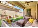 Comfortable covered patio with outdoor seating, ceiling fan, and artificial turf at 1930 W Yellowstone Way, Chandler, AZ 85248