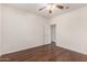 Bright bedroom showcases wood flooring, a fan, and an open doorway to another room at 2146 S Drexel --, Mesa, AZ 85209