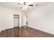 Bedroom featuring wood floors, ceiling fan, closet, and a door to another room at 2146 S Drexel --, Mesa, AZ 85209