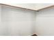 White walk-in closet features a wood floor and closet rods at 2146 S Drexel --, Mesa, AZ 85209