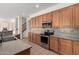 Kitchen showcasing wooden cabinets, stainless steel appliances, tiled backsplash, and countertops at 2146 S Drexel --, Mesa, AZ 85209