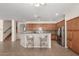 Spacious kitchen with wooden cabinetry, stainless steel appliances, and breakfast bar with seating at 2146 S Drexel --, Mesa, AZ 85209