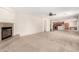 Open-concept living room with a fireplace, neutral carpet, and access to kitchen at 2146 S Drexel --, Mesa, AZ 85209