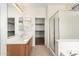 Bathroom featuring double sinks, vanity, large shower, and walk-in closet at 2146 S Drexel --, Mesa, AZ 85209