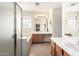 Bright main bathroom with double sinks, large mirrors, separate tub, and glass-enclosed shower at 2146 S Drexel --, Mesa, AZ 85209
