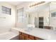 Main bathroom with double sinks, a large mirror, a separate tub, and a shower at 2146 S Drexel --, Mesa, AZ 85209