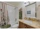 Bright bathroom with a shower-tub combo, granite vanity, and tiled flooring at 2315 E Cholla St, Phoenix, AZ 85028
