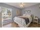 Cozy bedroom with a ceiling fan, tile flooring, and a large window at 2315 E Cholla St, Phoenix, AZ 85028