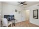 Bright bedroom offering tile flooring, a ceiling fan, and a modern desk setup at 2315 E Cholla St, Phoenix, AZ 85028