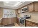 Efficient kitchen featuring wooden cabinetry, granite countertops, and stainless steel appliances at 2315 E Cholla St, Phoenix, AZ 85028