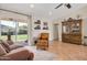 Cozy living room with tile floors, ceiling fan, and a sliding glass door offering backyard views at 2315 E Cholla St, Phoenix, AZ 85028