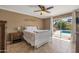 Relaxing main bedroom features tile flooring, a ceiling fan, and access to the backyard pool area at 2315 E Cholla St, Phoenix, AZ 85028