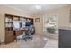 Well-lit home office with custom built-ins, a large desk, and tile flooring at 2315 E Cholla St, Phoenix, AZ 85028