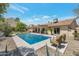 Backyard oasis with a sparkling pool, manicured landscaping, and shaded seating area at 2315 E Cholla St, Phoenix, AZ 85028