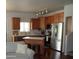 Open concept kitchen features stainless appliances, wood cabinets and breakfast bar seating at 2401 E Rio Salado Pkwy # 1225, Tempe, AZ 85288