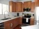 Bright kitchen with stainless steel appliances, light countertops and wood cabinets at 2401 E Rio Salado Pkwy # 1225, Tempe, AZ 85288