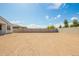 Large backyard with a block fence, offering privacy and potential landscaping opportunities at 24356 W La Salle St, Buckeye, AZ 85326