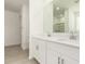 A spacious bathroom featuring double sinks, white cabinets, and a walk-in shower at 24356 W La Salle St, Buckeye, AZ 85326