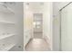 Bathroom with double sinks, white cabinets, a walk-in shower, and a walk-in closet at 24356 W La Salle St, Buckeye, AZ 85326