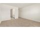 Bedroom with a carpeted floor, white walls, and views into the bathroom at 24356 W La Salle St, Buckeye, AZ 85326