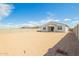Backyard view of home showing covered patio, neutral color scheme, and privacy fence at 24356 W La Salle St, Buckeye, AZ 85326