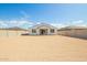 Backyard view of home showing covered patio, neutral color scheme, and block fence at 24356 W La Salle St, Buckeye, AZ 85326