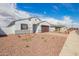 Charming single-story home with paver driveway, rock landscaping and view of neighborhood street at 24356 W La Salle St, Buckeye, AZ 85326