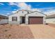 Charming single-story home with a two-car garage, paver driveway, and low-maintenance desert landscaping at 24356 W La Salle St, Buckeye, AZ 85326