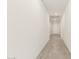 Bright hallway with tile flooring and recessed lighting leading to a white interior door at 24356 W La Salle St, Buckeye, AZ 85326
