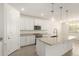 A modern kitchen featuring white cabinets, granite countertops, and stainless steel appliances at 24356 W La Salle St, Buckeye, AZ 85326