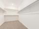 Spacious walk-in closet featuring carpet floors and ample shelving for optimal organization at 24356 W La Salle St, Buckeye, AZ 85326