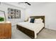 A cozy bedroom featuring a comfortable bed, stylish dresser, and bright natural light from the window at 2511 W Queen Creek Rd # 165, Chandler, AZ 85248