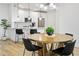 Kitchen view with island and a round wooden dining table, showcasing modern and open-concept design at 2511 W Queen Creek Rd # 165, Chandler, AZ 85248
