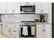 Kitchen with stainless steel oven, white cabinets and a backsplash with modern herringbone pattern at 2511 W Queen Creek Rd # 165, Chandler, AZ 85248