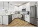 Bright kitchen showcasing stainless steel appliances, white cabinets, and an open layout at 2511 W Queen Creek Rd # 165, Chandler, AZ 85248