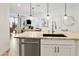 Kitchen features a stainless steel dishwasher and sink, complimented by an open floorplan to the living spaces at 2511 W Queen Creek Rd # 165, Chandler, AZ 85248