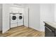 Bright laundry room featuring modern side-by-side washer and dryer units and ample storage cabinets at 2511 W Queen Creek Rd # 165, Chandler, AZ 85248